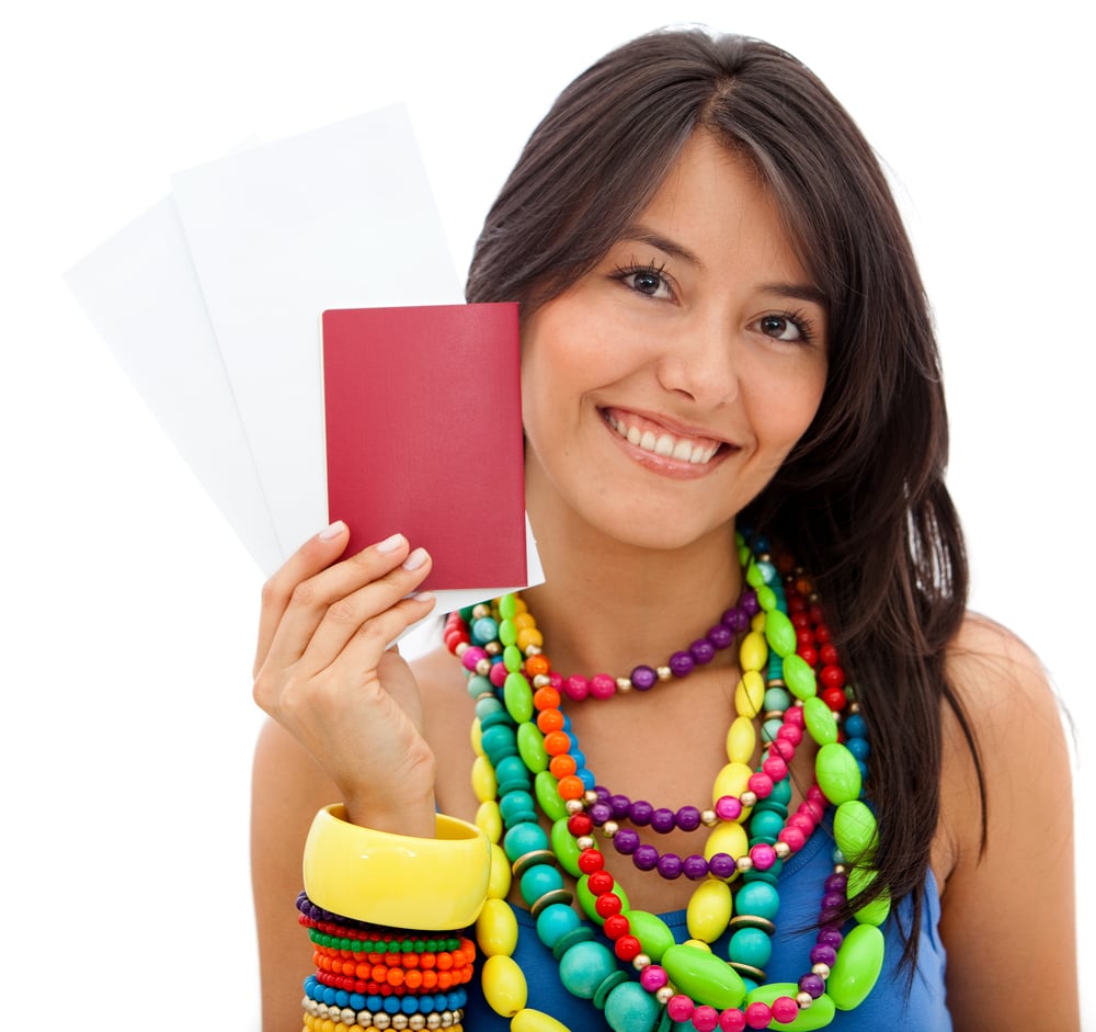Colorful woman holding her passport isolated over a white background